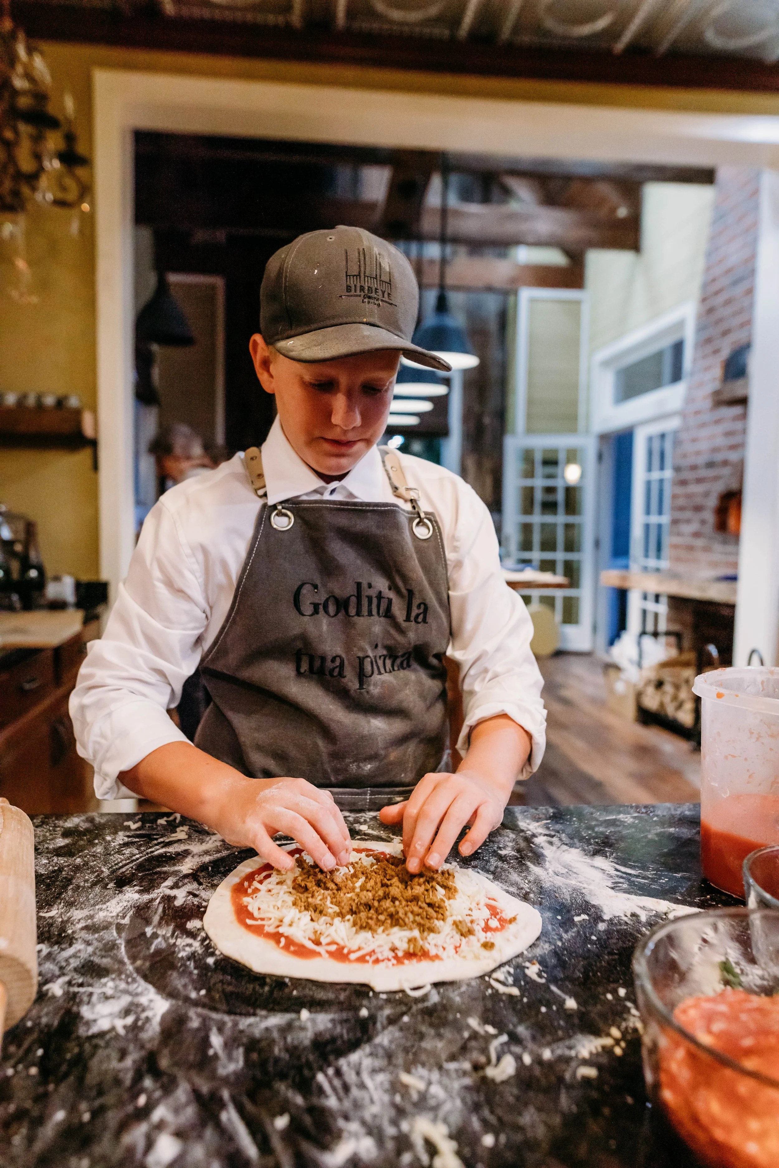 Inside the 1903 house kitchen — Birdeye Farms hat, brick, French doors